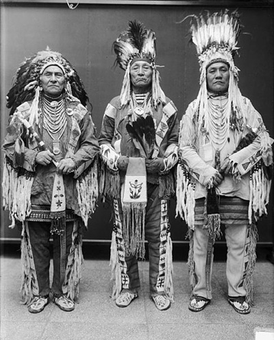 Three Blackfoot Chiefs wearing traditional clothing