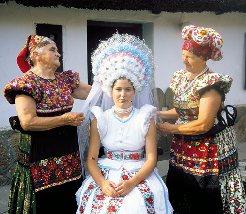 Hungarian bride and older women in traditional outfits