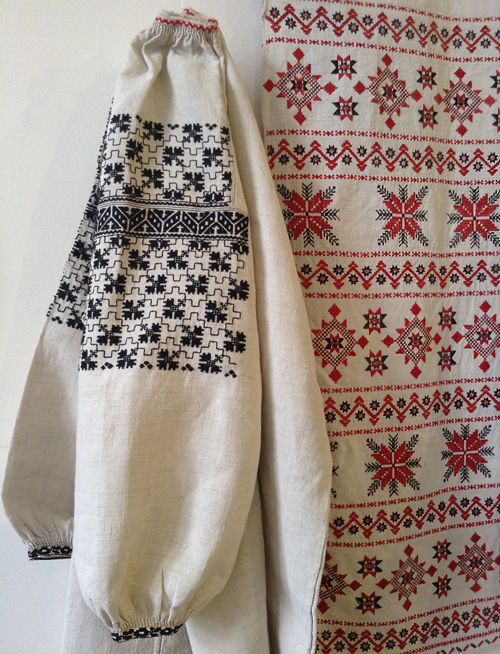 Embroidery designs on the sleeve of female shirt and festive towel