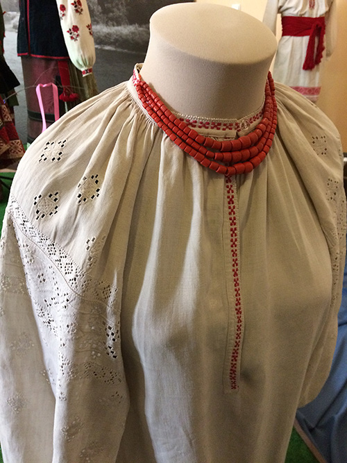 Women’s embroidered shirt and coral necklace from Ukraine early 20th century