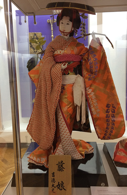 Beautiful Japanese doll wearing traditional clothing