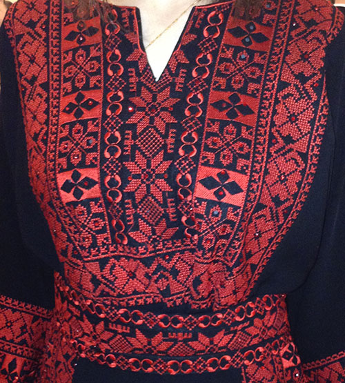 Bright-red embroidery on Palestinian folk dress