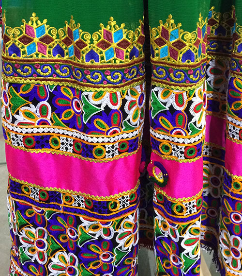 Traditional bridal dress from Afghanistan adorned with multicolored embroidery designs