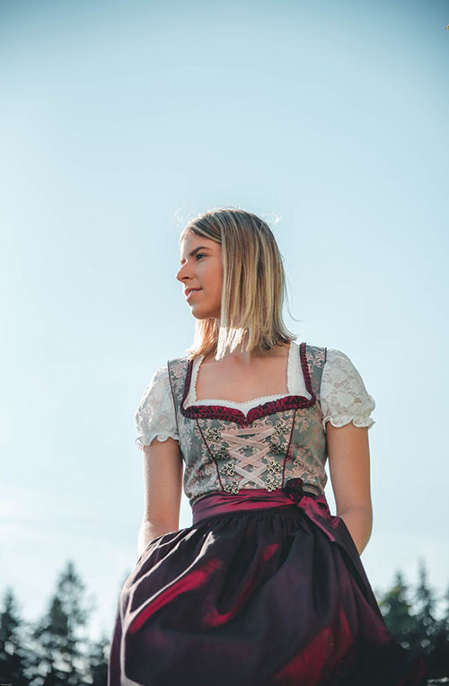 Austrian old and modern traditions of wearing dirndl dress