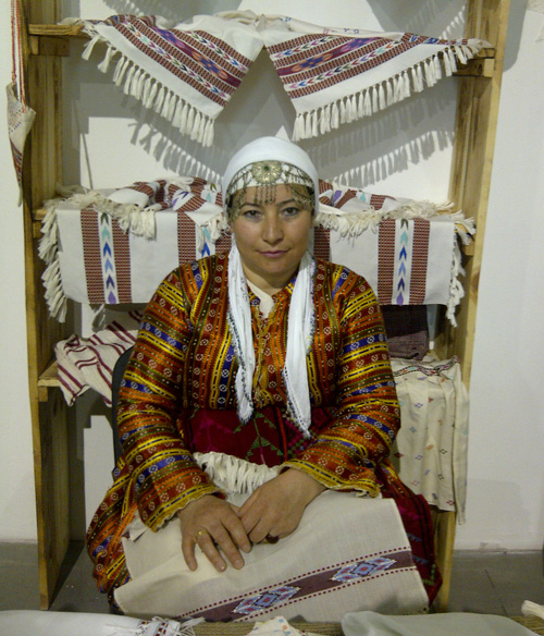 Turkish woman in national clothing with Turkish embroidered towels