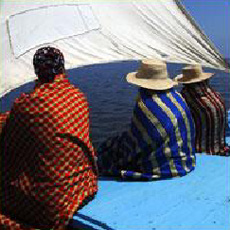 Men wrapped in traditional Tunisian woven blankets