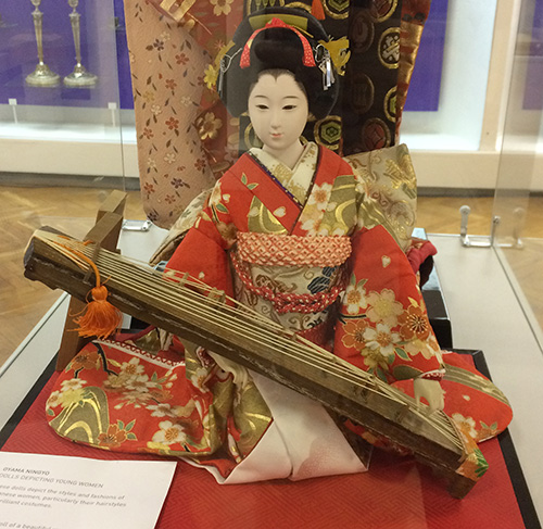 Lovely Japanese doll wearing traditional clothing