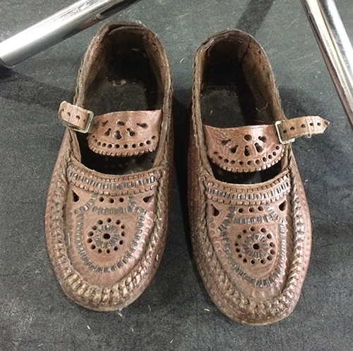 Female leather shoes from western Ukraine embellished with cutting and stamping on leather