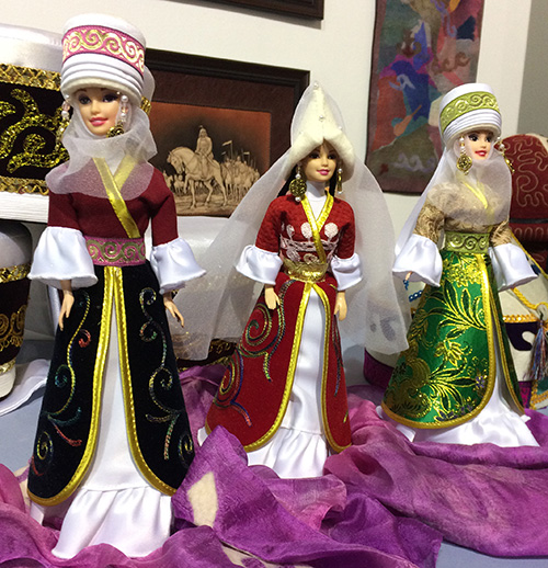 Kyrgyz dolls wearing rather accurate tiny Kyrgyz traditional outfits