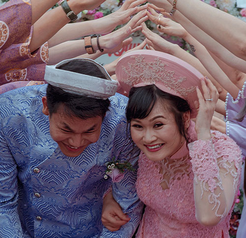 Vietnamese bride and groom wearing khan dong headdresses