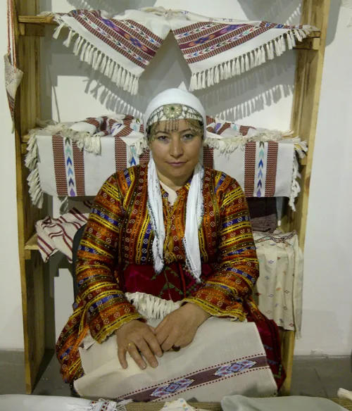 Turkish woman in national clothing with Turkish embroidered towels