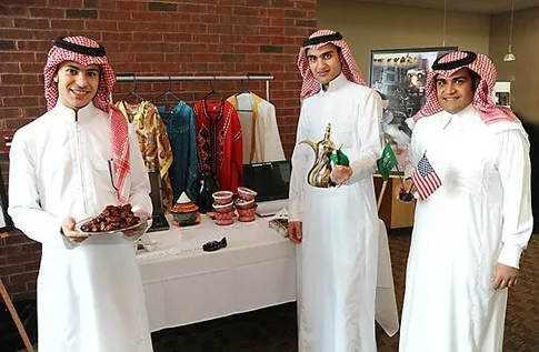 Traditional clothing of Saudi Arabia. Men in white, women in black