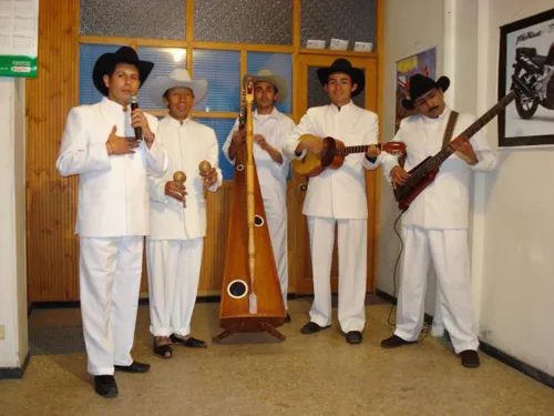 Traditional costume of Venezuela. Liqui liqui for men, flowing ruffled dresses and floral decorations for women