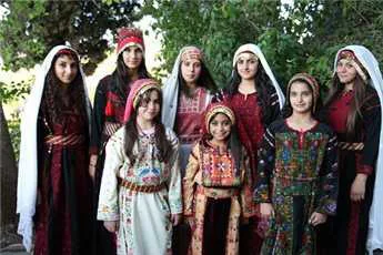 Traditional costume of Palestine. Loose robes, plenty of embroidery, elaborate headdresses, and silver jewelry