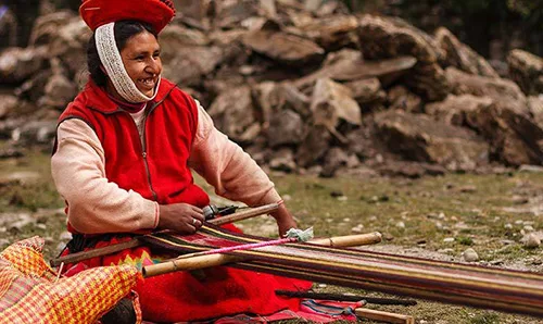 Peruvian woman in the process of weaving