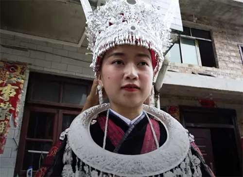 Miao bride is traditionally covered in silver jewelry from head to toe