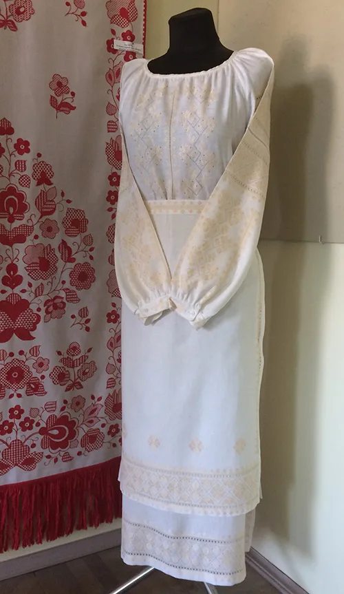 Very delicate modern women’s outfit embellished with peach-color embroidery