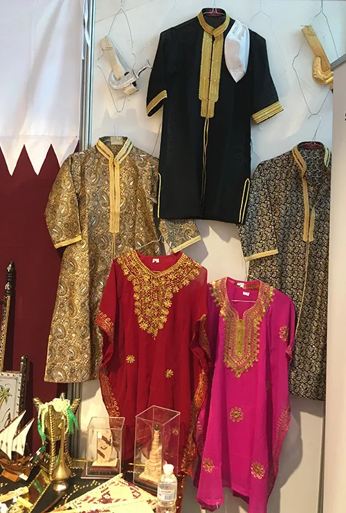 Kid folk clothing in Qatar is much more colorful than adult traditional dress