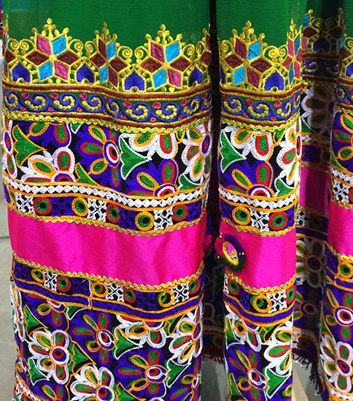Traditional bridal dress from Afghanistan adorned with multicolored embroidery designs