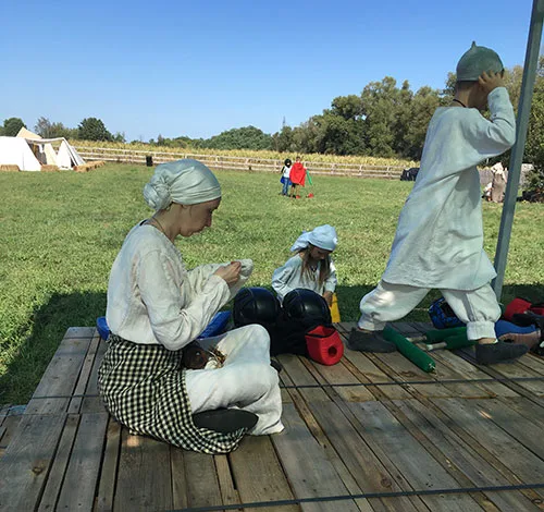 Medieval peasant woman embroidering