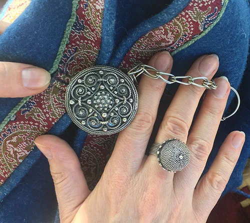 Modern replicas of silver round brooch and finger ring typical for Kyivan Rus