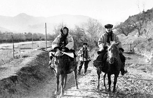 Ukrainian Hutsul married couple riding horses in traditional clothing and outerwear Western Ukraine early 20th century