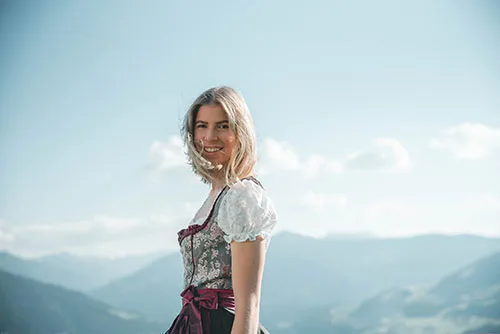 Austrian old and modern traditions of wearing dirndl dress