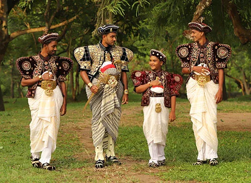 Sri Lankan grooms in traditional embroidered velvet jackets and hats outshine their brides